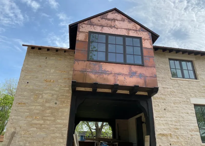 Copper metal panel facade on a stone building for Skylight Installation in Millcreek