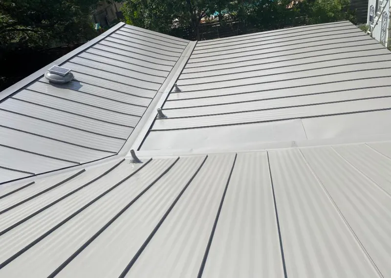 Solar attic fan installed on a metal roof for Roof Ventilation in Millcreek